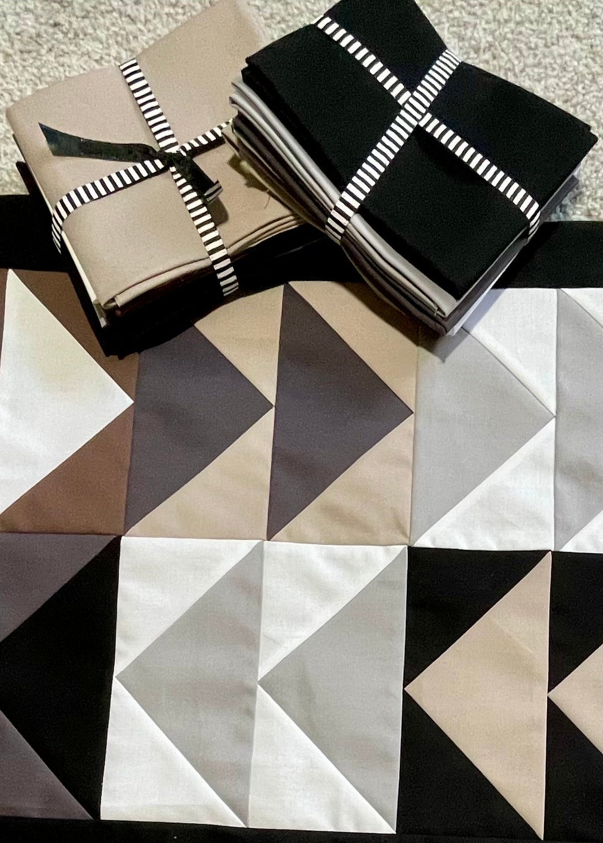 Geometric patterned rug with a box on a carpeted floor