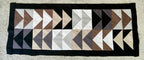 Geometric patterned rug with triangles on a plain background