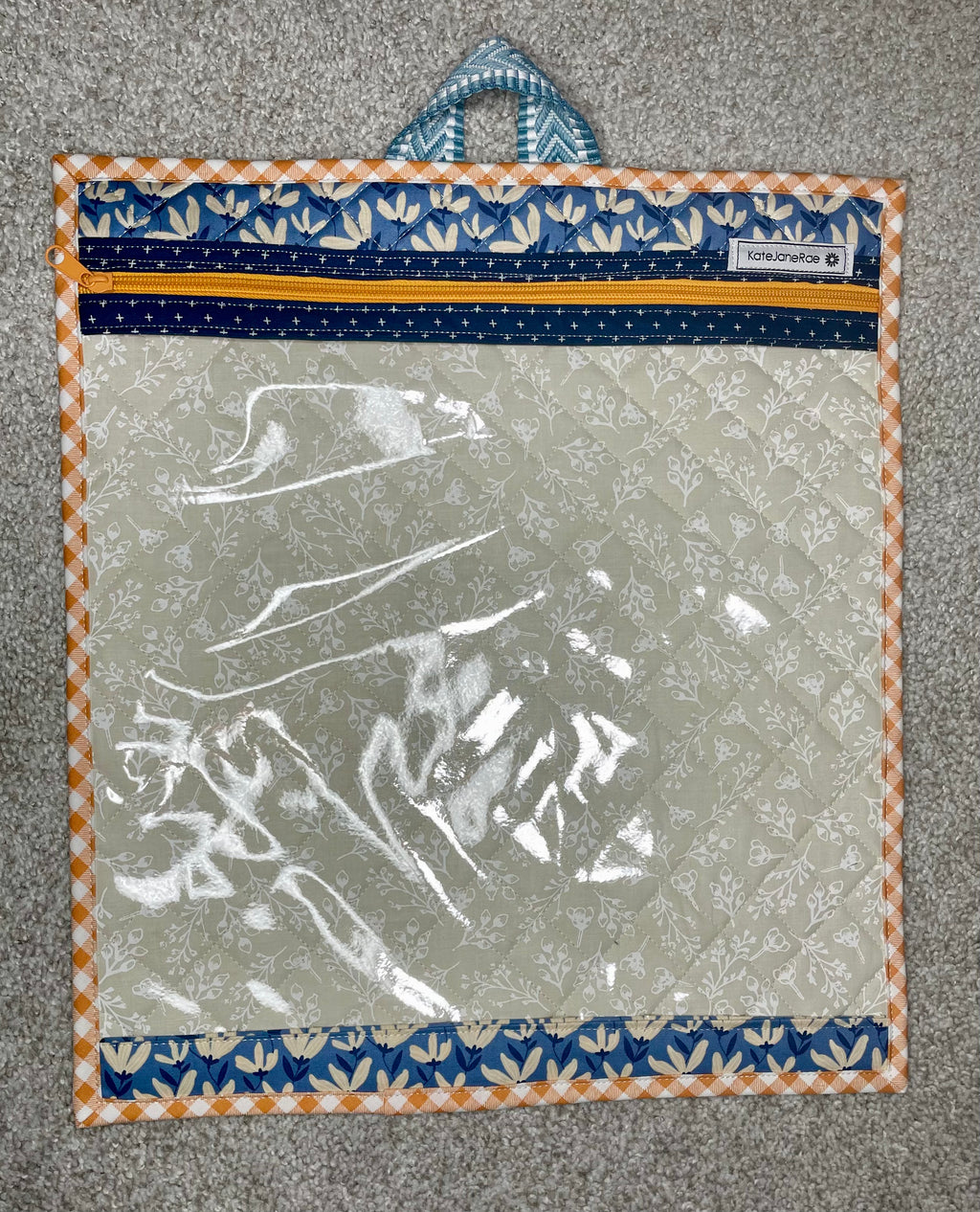 Clear plastic bag with floral border on a textured surface