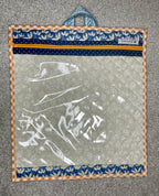 Clear plastic bag with floral border on a textured surface