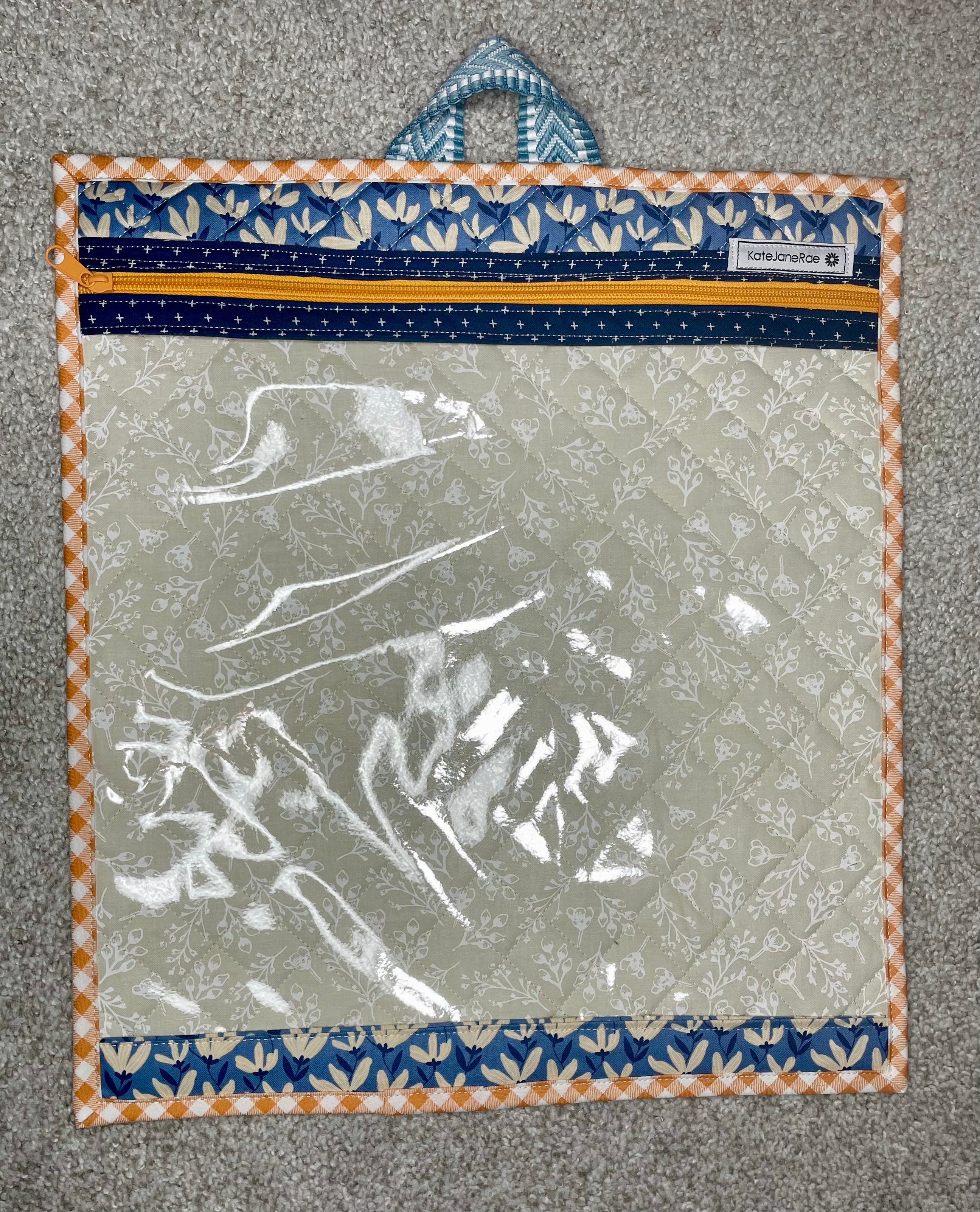 Clear plastic bag with floral border on a textured surface