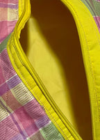 Plaid pouch with yellow interior on a white background