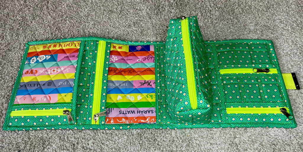 Colorful fabric wallet with multiple compartments on a gray surface