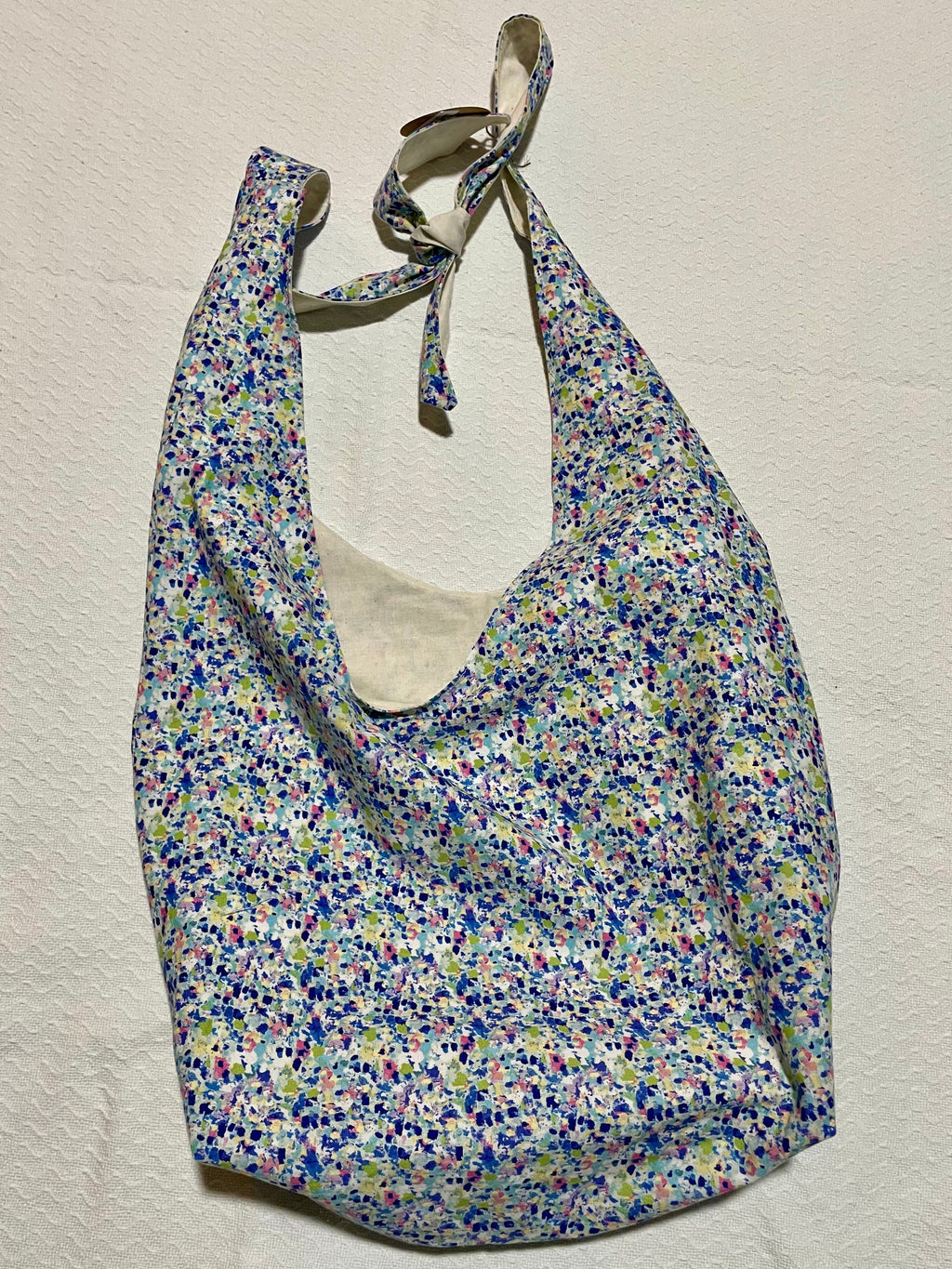 Floral patterned bag on a beige background