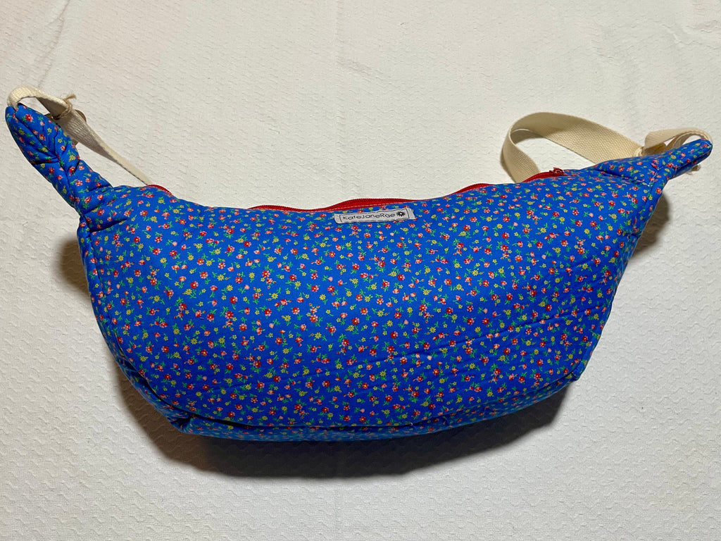 Blue patterned bag with a strap on a light beige background