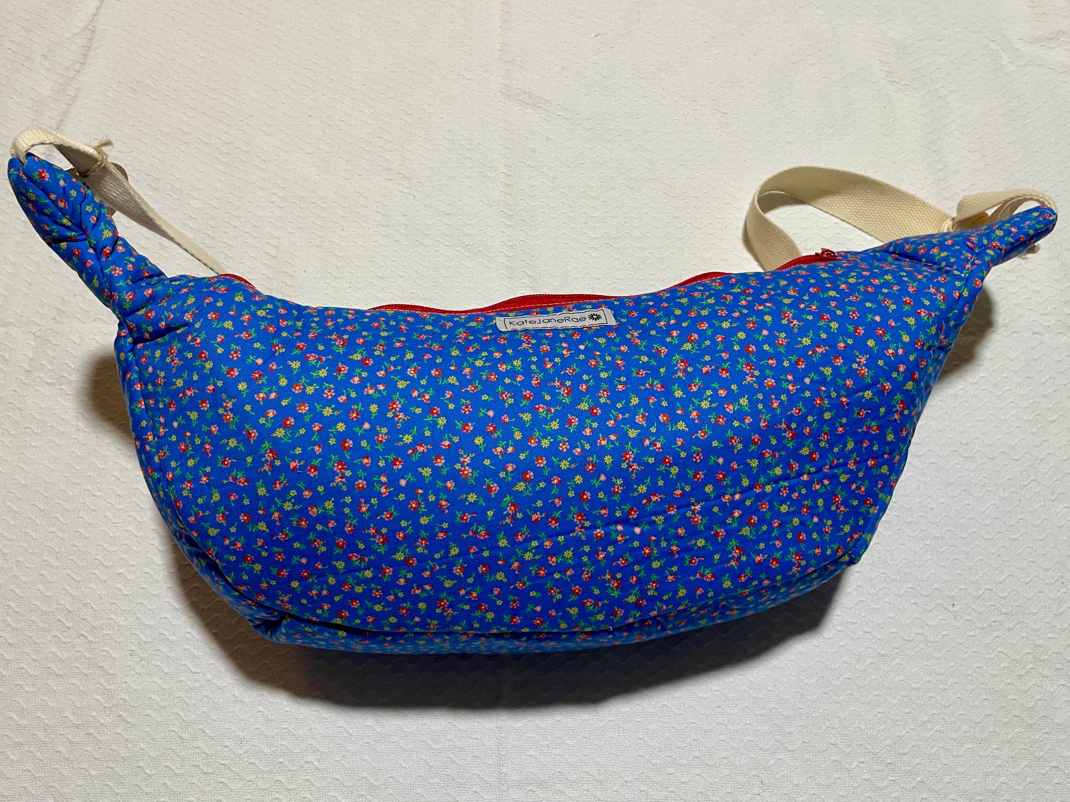 Blue patterned bag with a strap on a light beige background