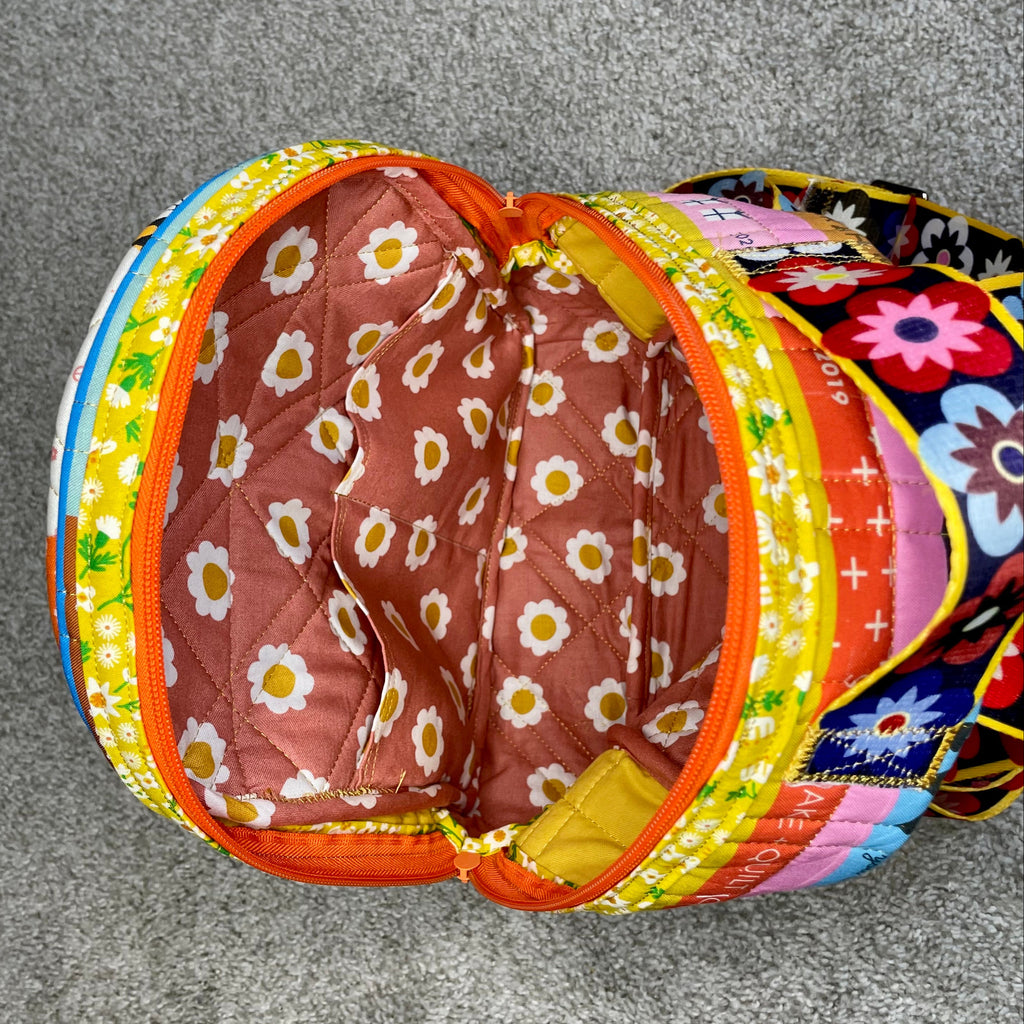 Colorful pet play tunnel with floral pattern on a gray floor