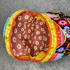 Colorful pet play tunnel with floral pattern on a gray floor