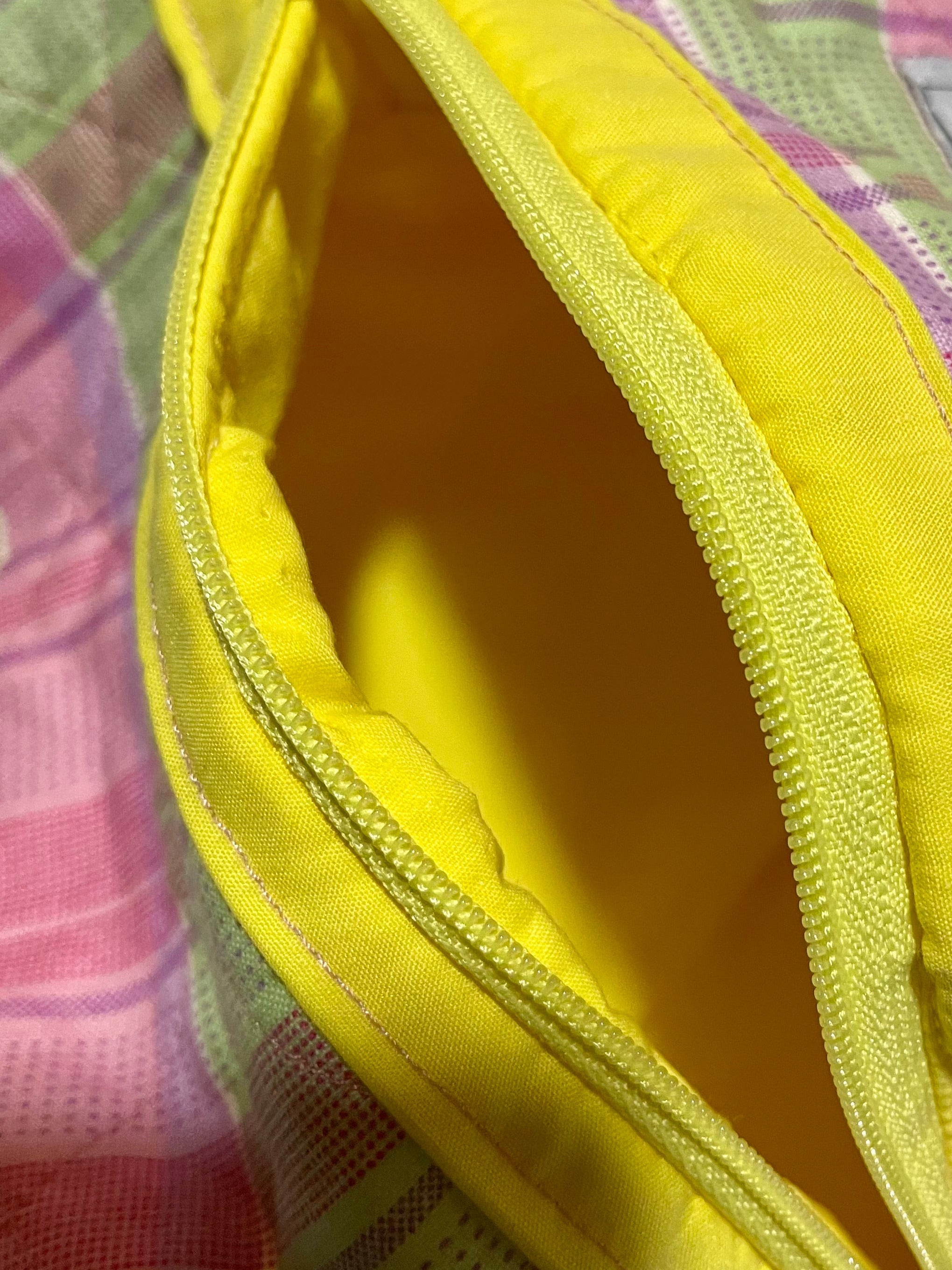 Multicolored pouch with a yellow interior on a white background