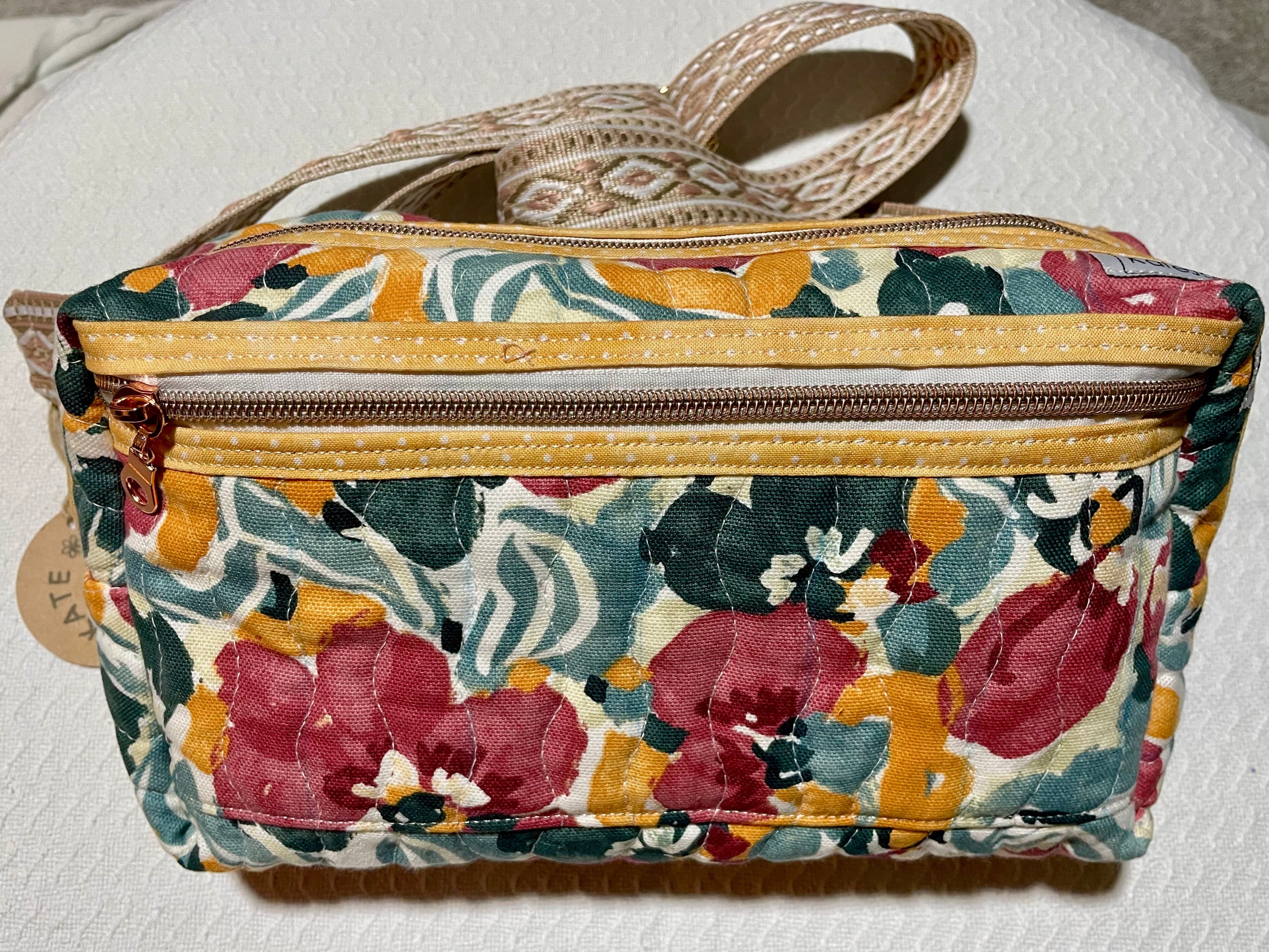 Floral patterned pouch with a zipper on a white background