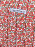 Floral-patterned tote bag on a wooden chair outdoors