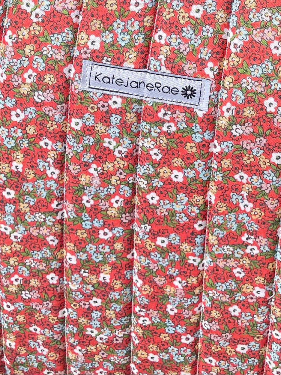 Floral-patterned tote bag on a wooden chair outdoors