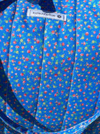 Blue patterned bag on a wooden chair outdoors