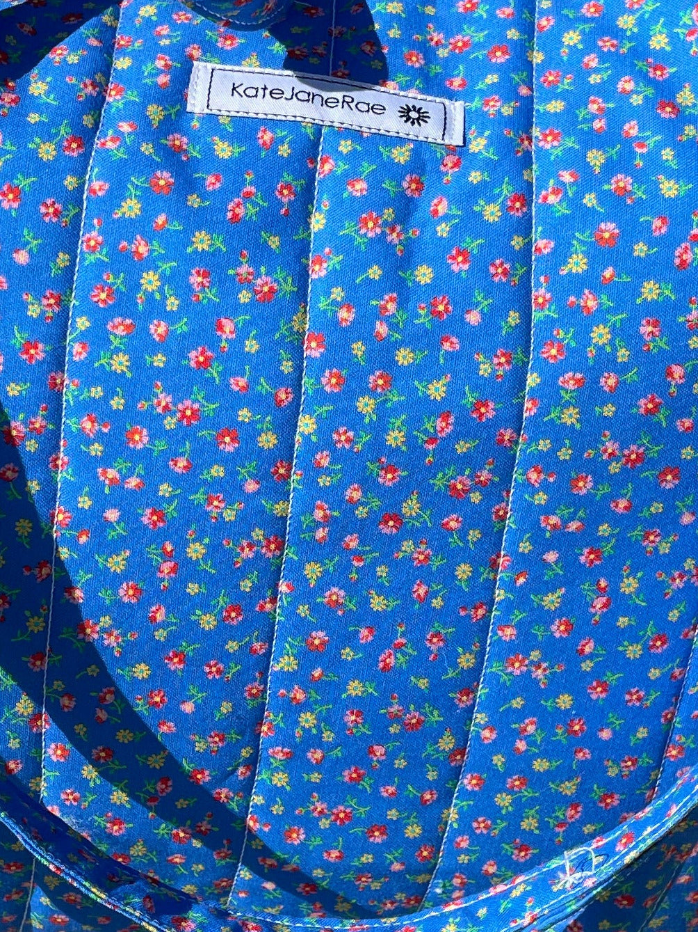 Blue patterned bag on a wooden chair outdoors