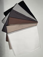 Fabric swatches in black, gray, brown, beige, and white on a light gray background