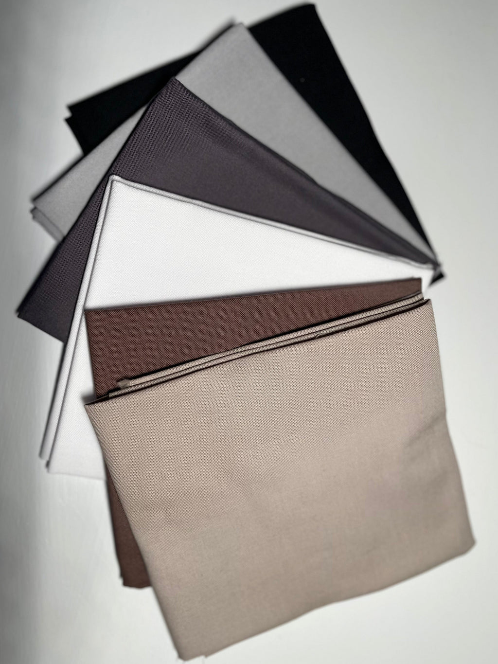 Collection of fabric swatches in various colors on a white background