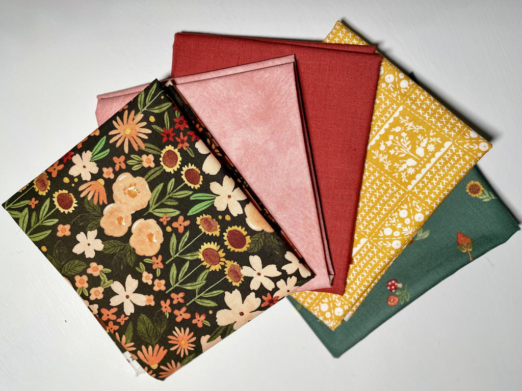 Colorful fall fabric bundle on white table