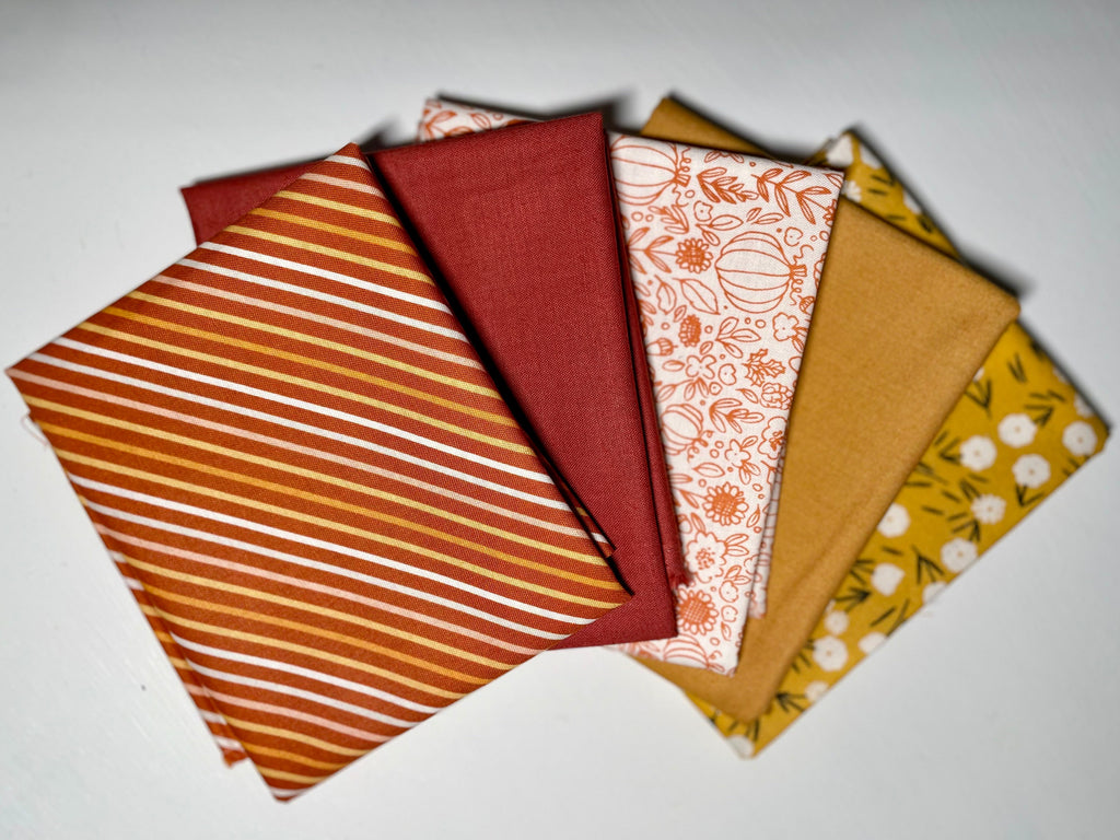 Golden Fall fabric bundle on white table