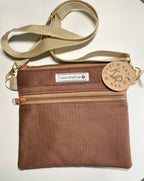Brown pouch with a strap and visible branding on a white background