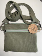 Green bag with a strap and visible brand logo on a white background