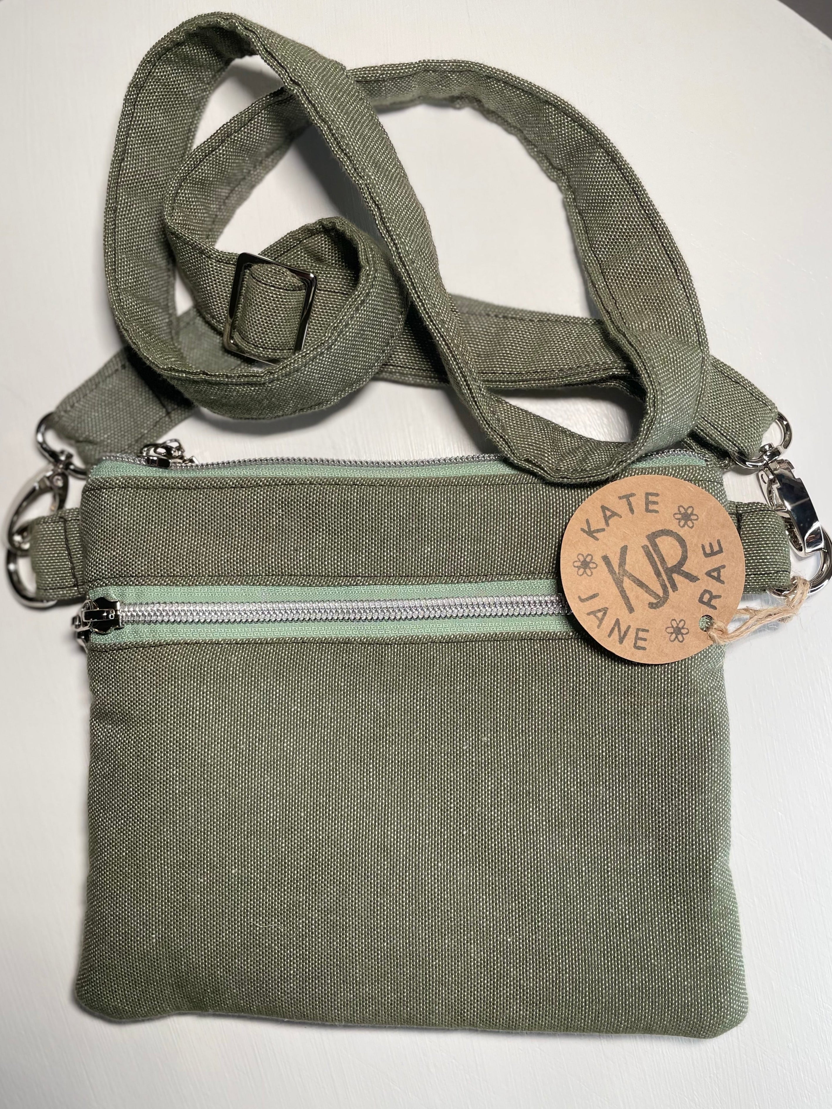 Green bag with a strap and visible brand logo on a white background