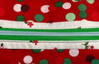 Red polka dot pouch with green and white zipper on a light gray background