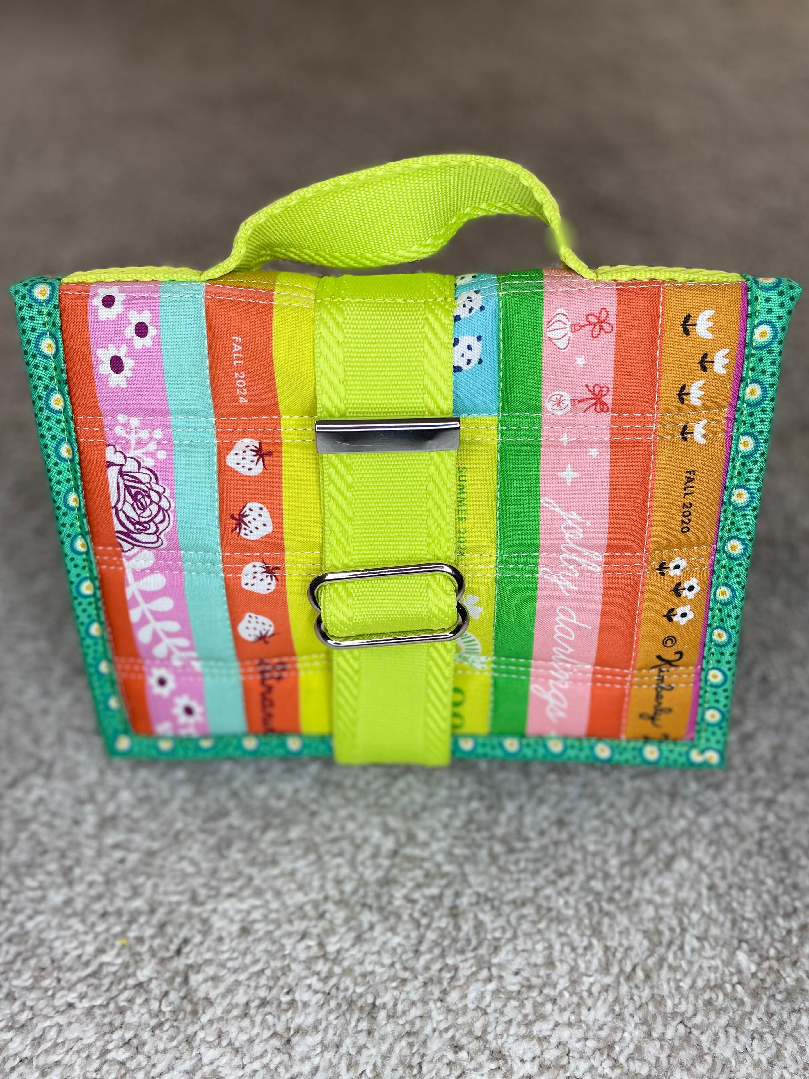 Colorful striped bag with a handle on a gray surface