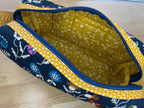 Fabric with blue and yellow pattern on a wooden surface