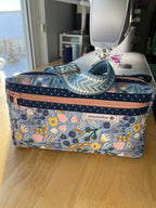 Floral-patterned pouch with a zipper on a wooden surface