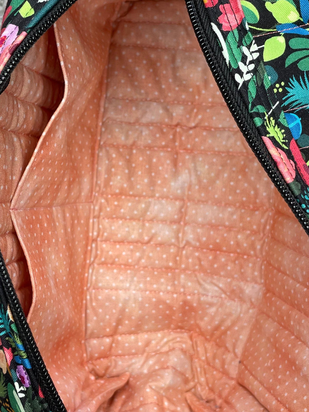 Floral-patterned fanny pack on a gray surface