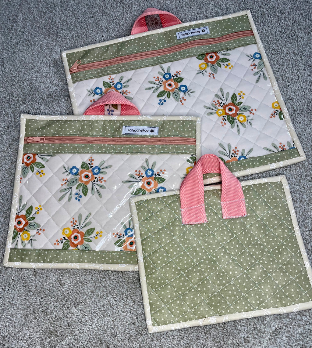Set of three fabric bags with floral patterns on a gray surface