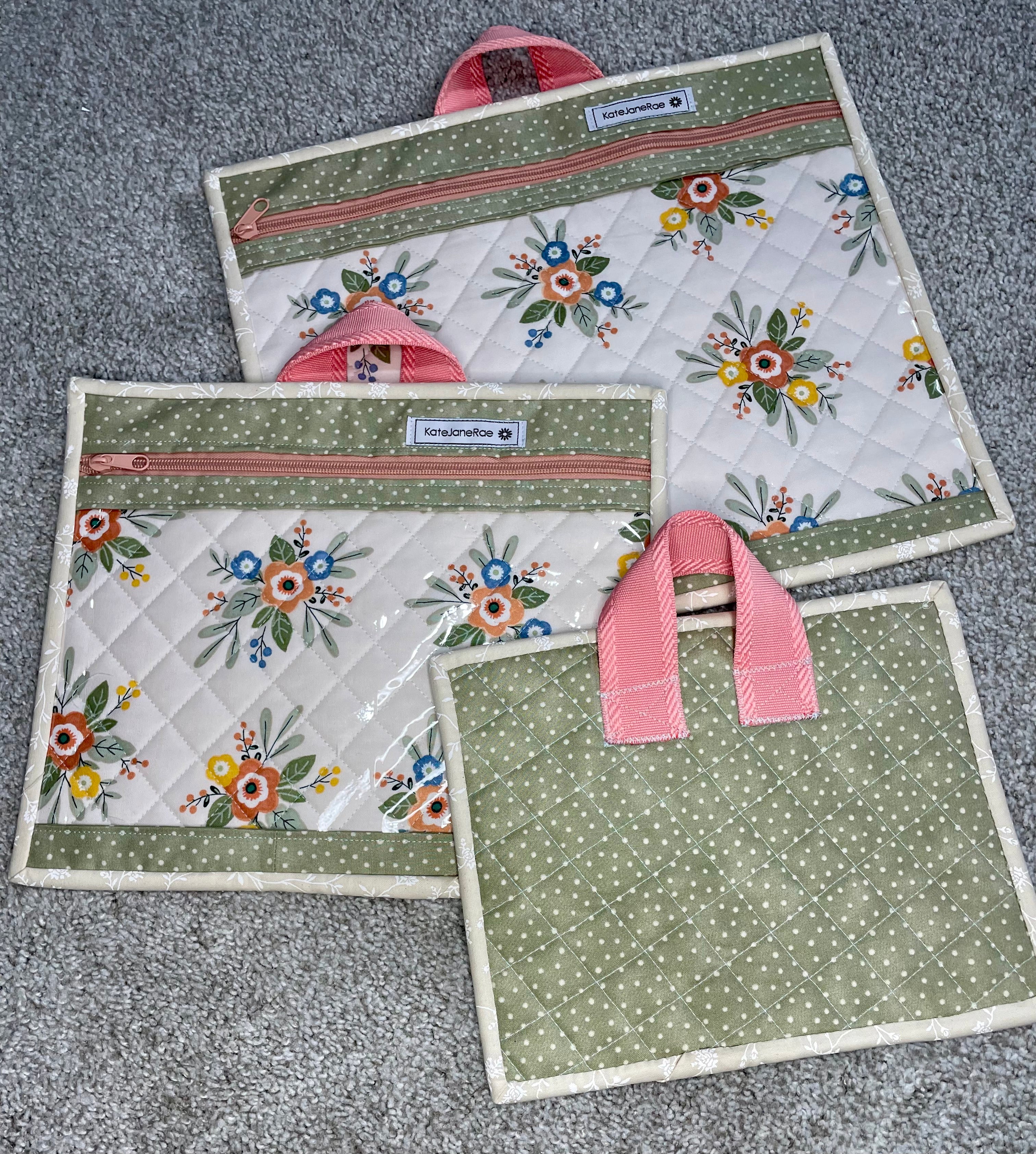 Set of three fabric bags with floral patterns on a gray surface