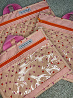 Set of three quilted pouches with decorative patterns on a textured surface