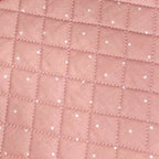 Set of pink quilted bags with polka dot pattern on a gray surface