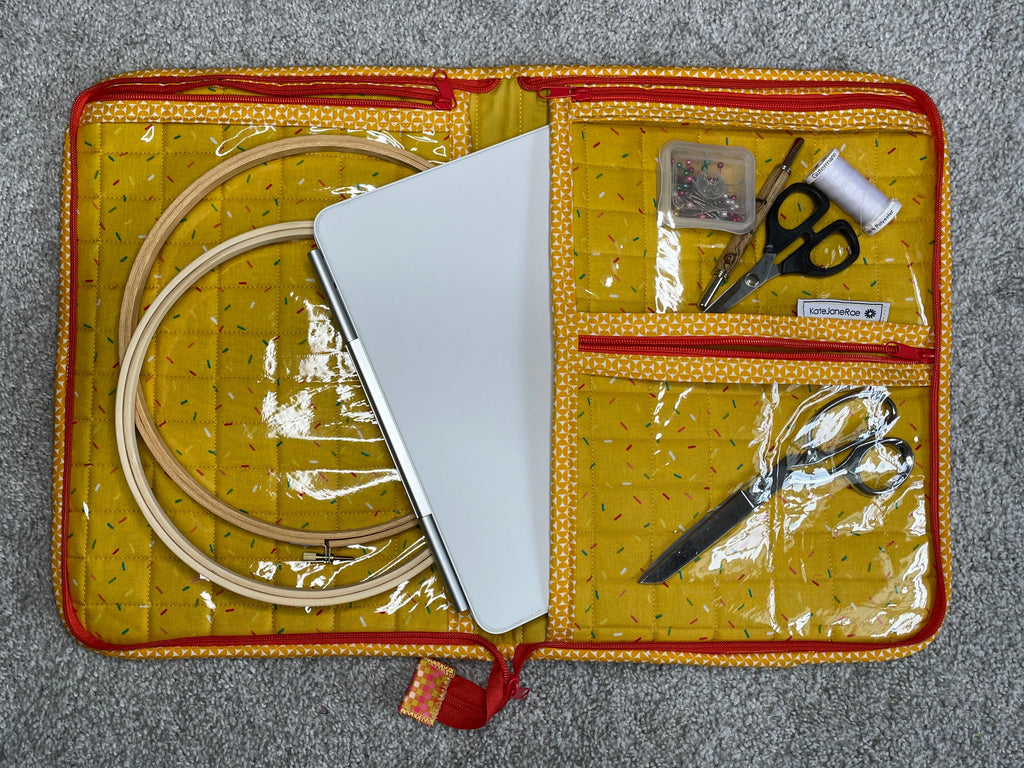 Embroidery kit with scissors, thread, and hoop on a gray surface