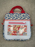 Fabric bag with floral and checkered patterns on a gray surface