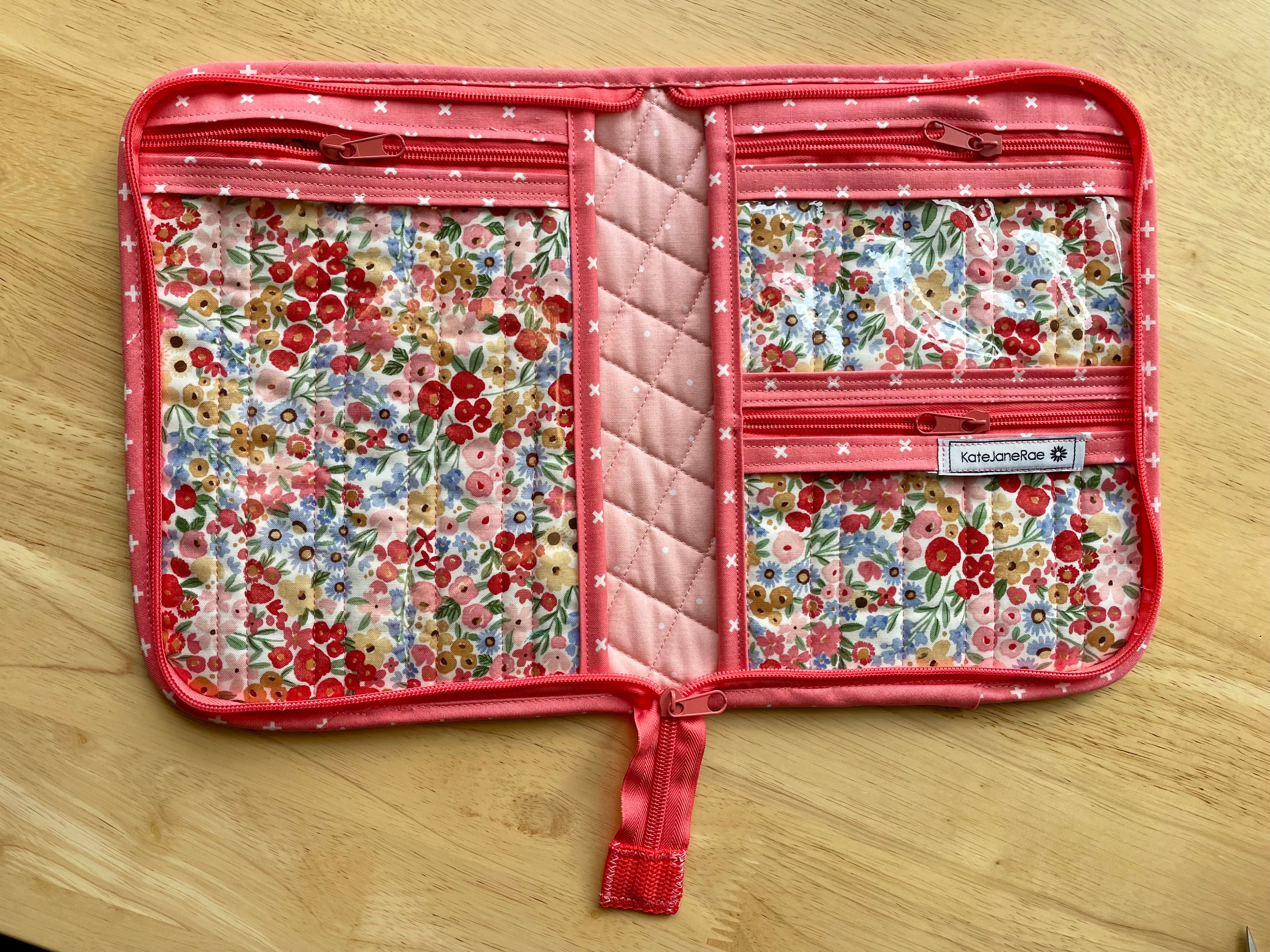Floral-patterned travel organizer on a wooden surface