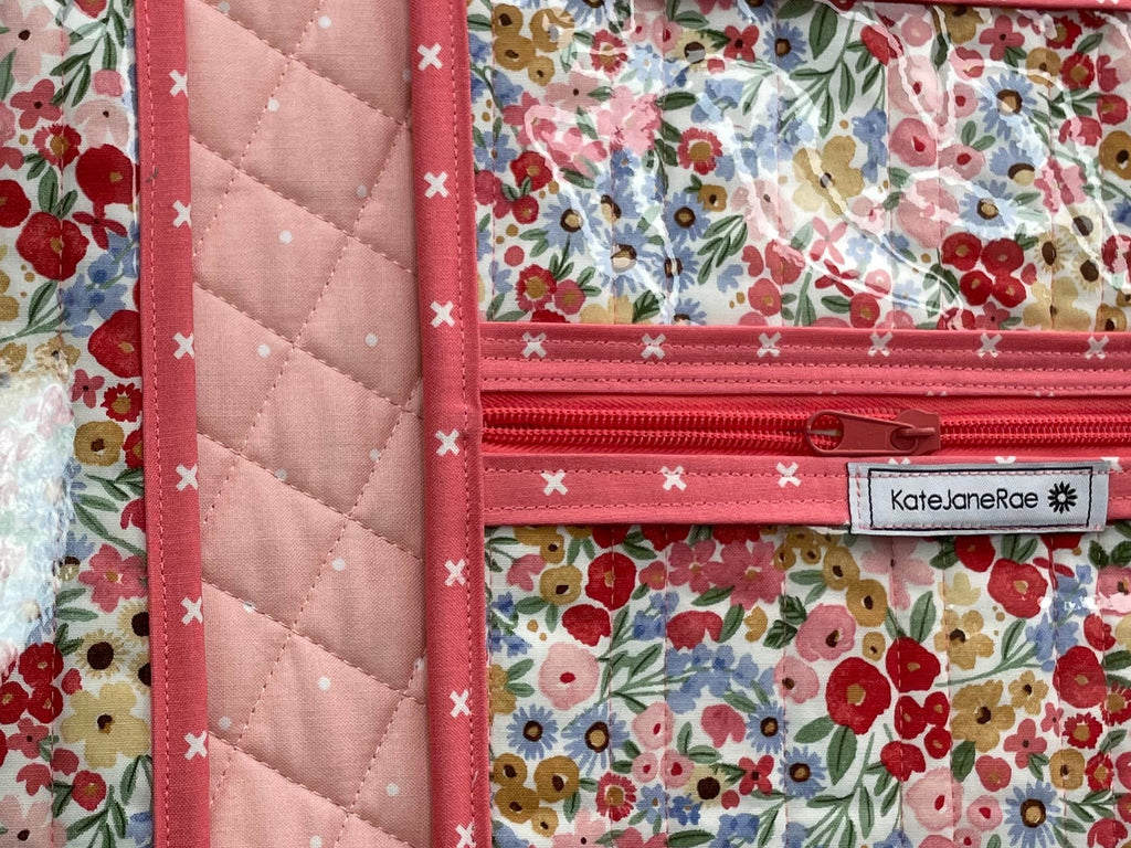 Floral-patterned travel organizer on a wooden surface