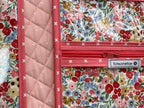 Floral-patterned travel organizer on a wooden surface