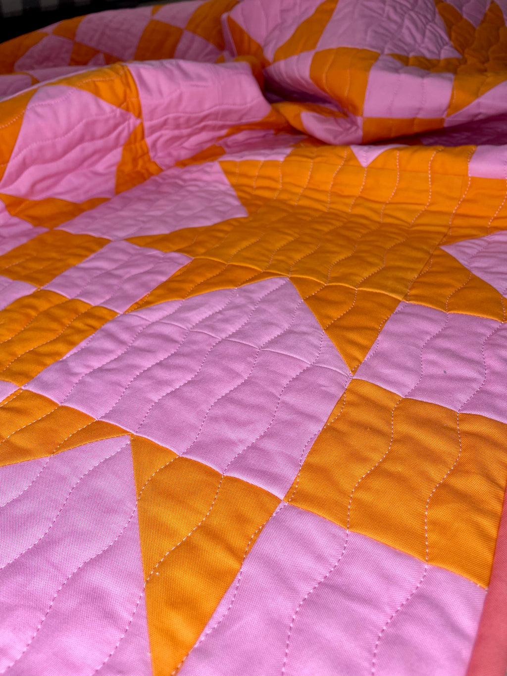 Quilt with pink and orange diamond pattern