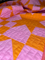 Quilt with pink and orange diamond pattern