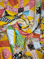 Colorful patchwork quilt with various patterns and colors.