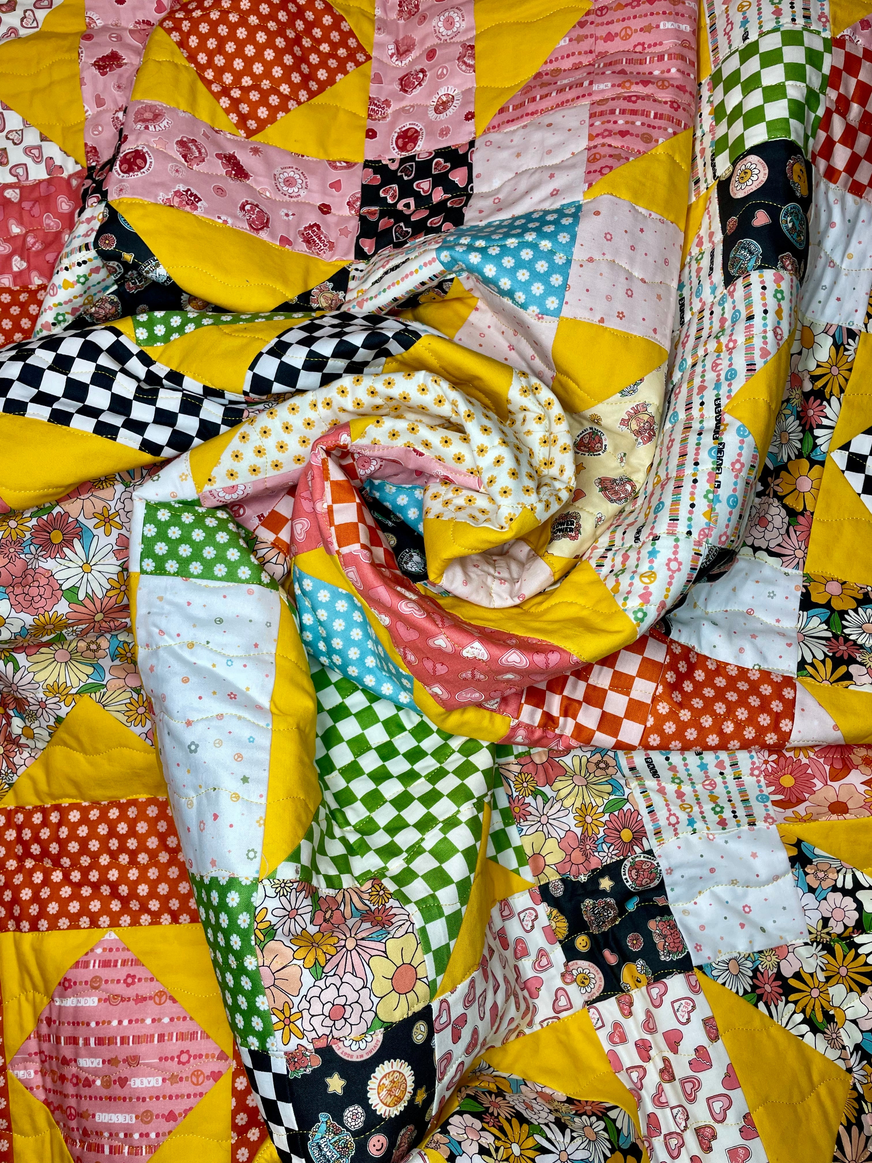 Colorful patchwork quilt with various patterns and colors.