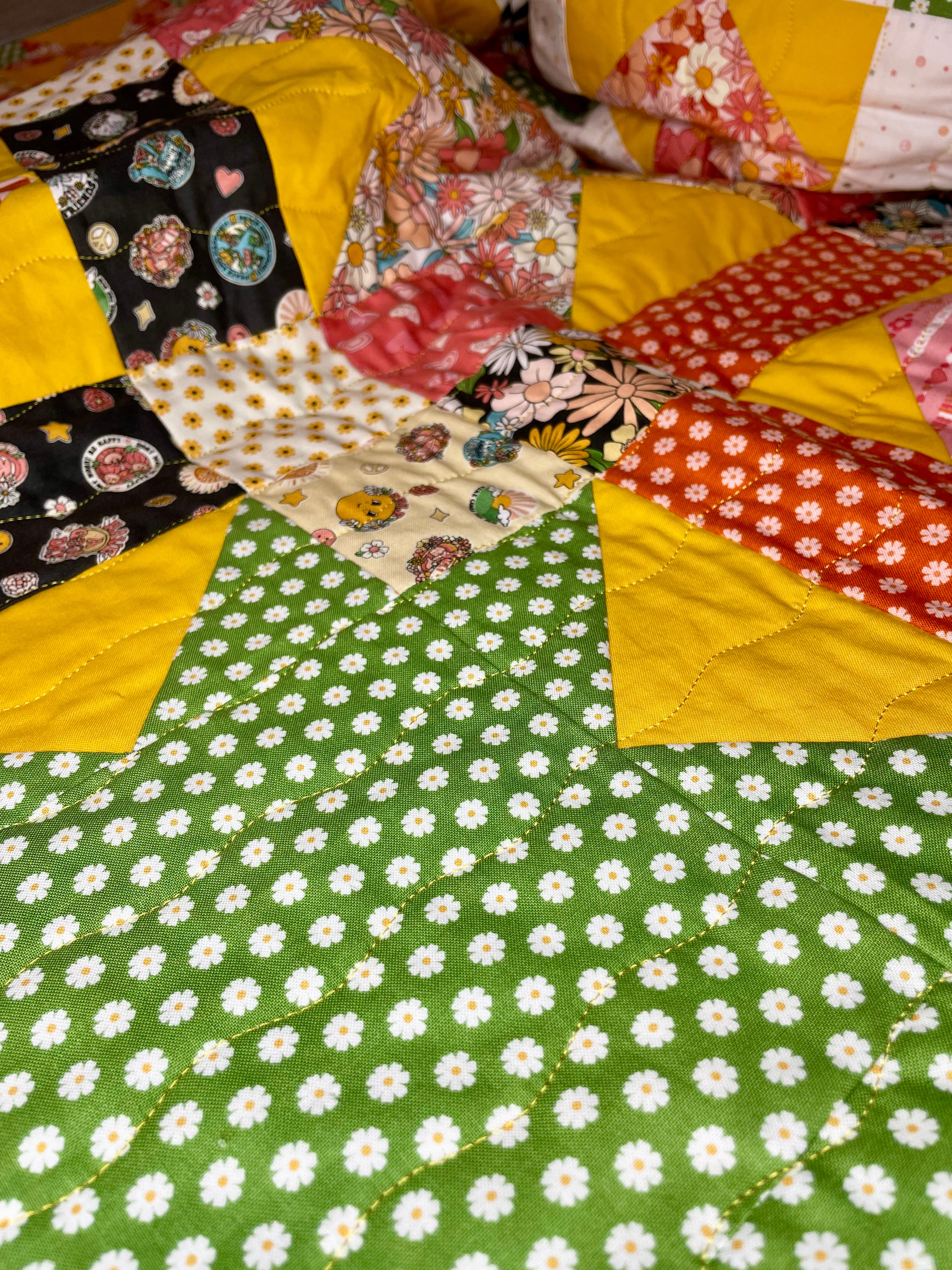 Patchwork quilt with floral and polka dot patterns on a green background