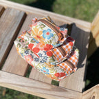 Colorful fabric bags on a wooden chair outdoors