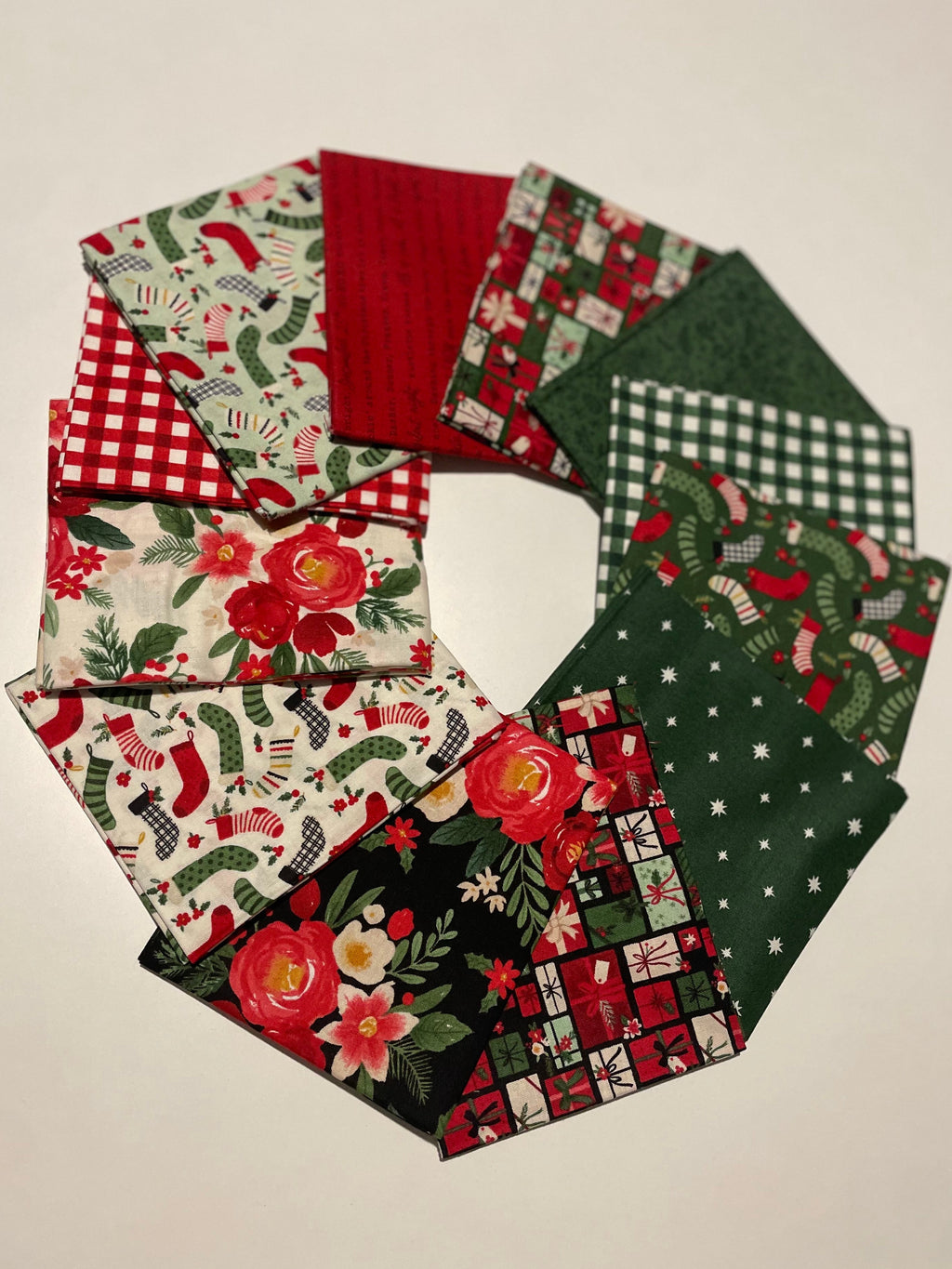 Collection of festive fabric swatches with Christmas patterns on a beige background