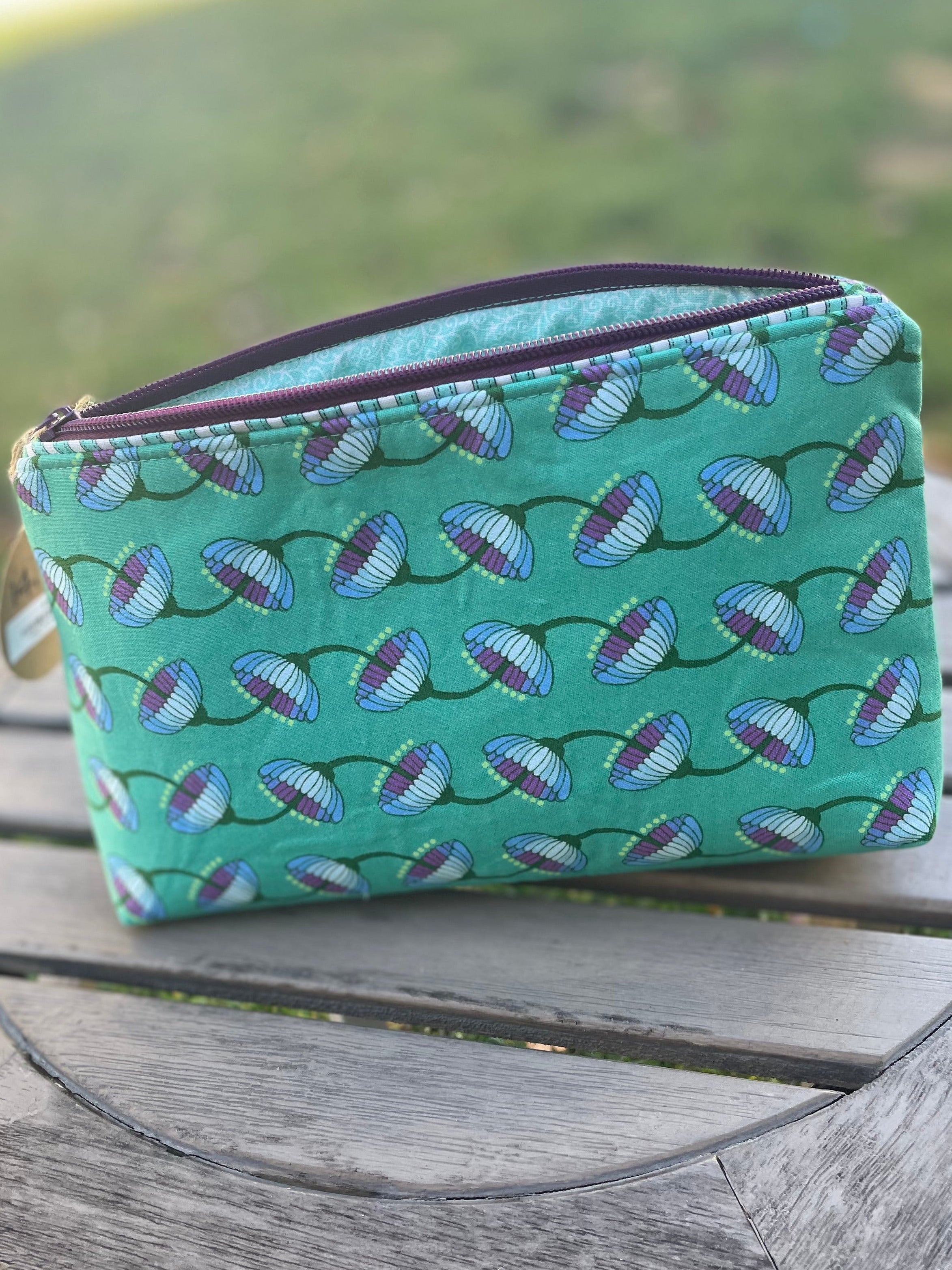 Small green pouch on wooden table.