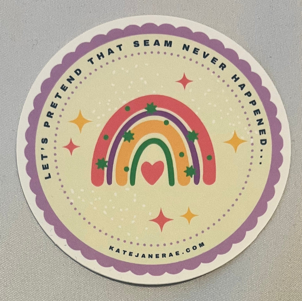 Circular sticker with colorful design on a gray surface