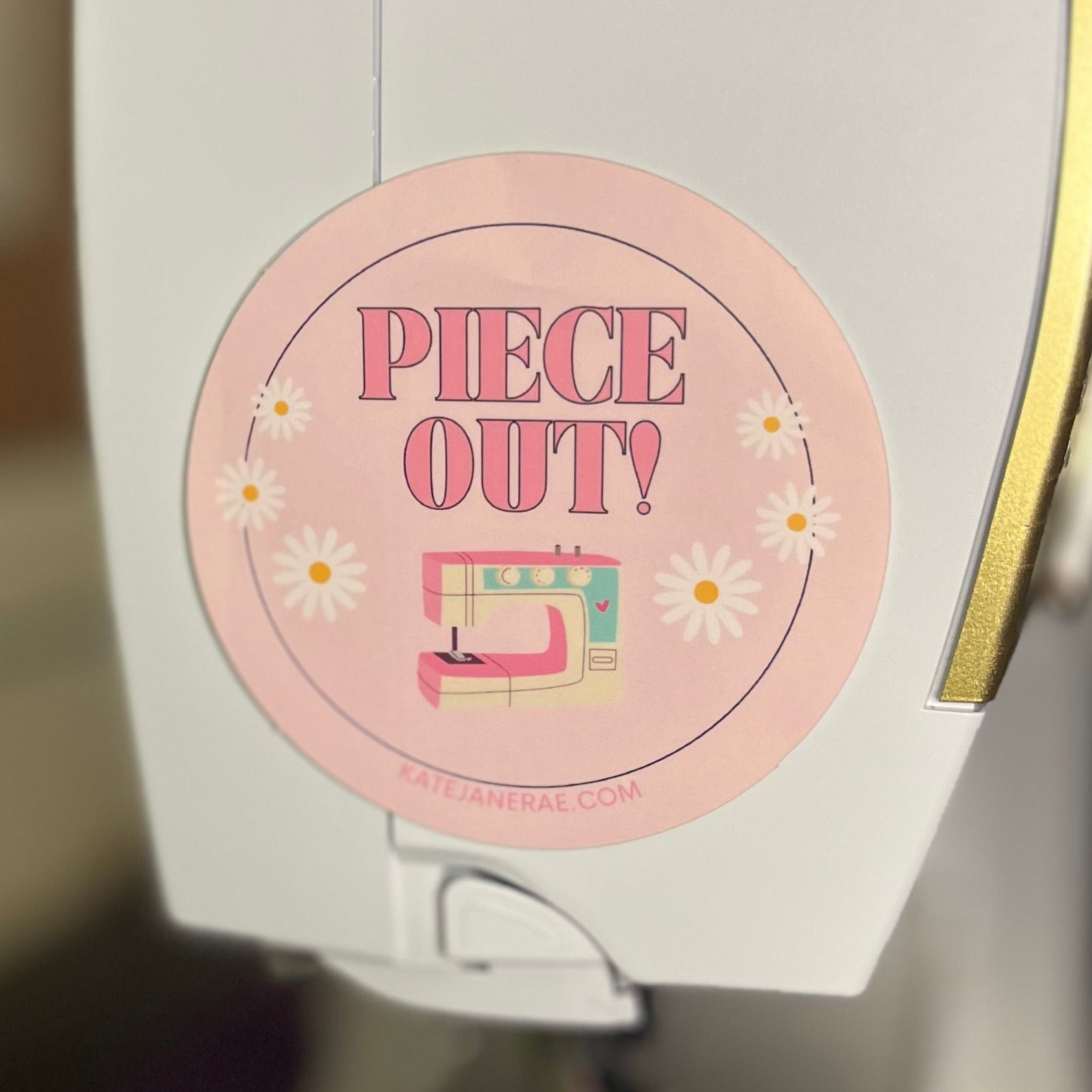 Sewing machine with a 'Piece Out!' label on a blurred background