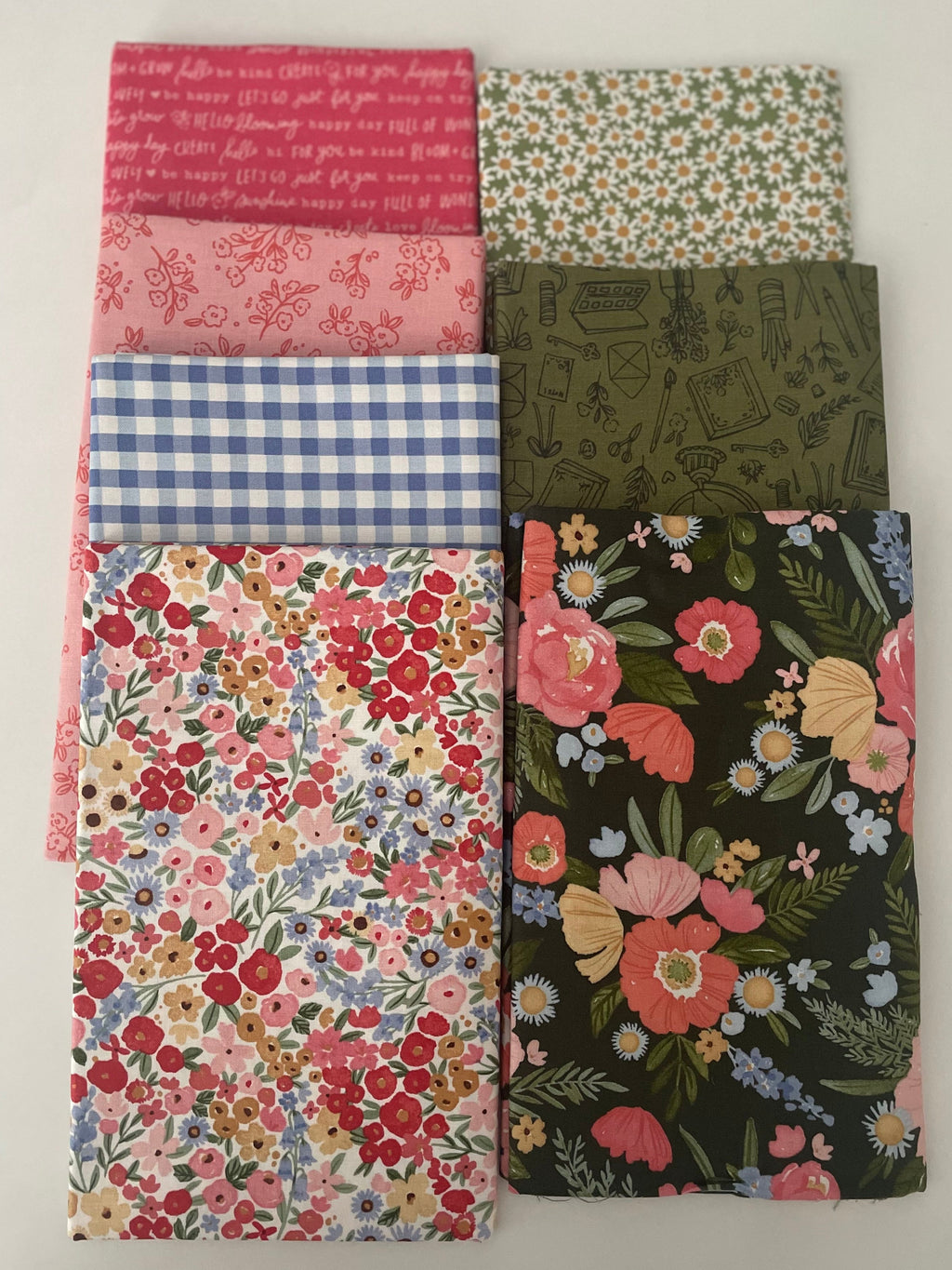 Collection of floral and patterned fabric swatches on a white background